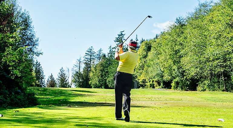 Golfer teeing off