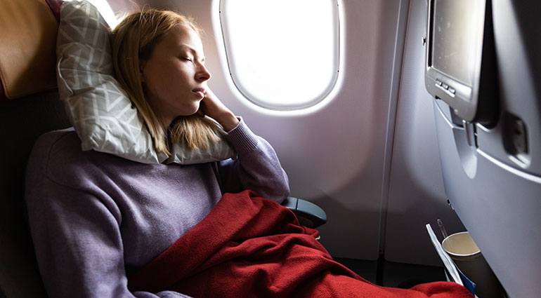 Woman resting on a plane trip