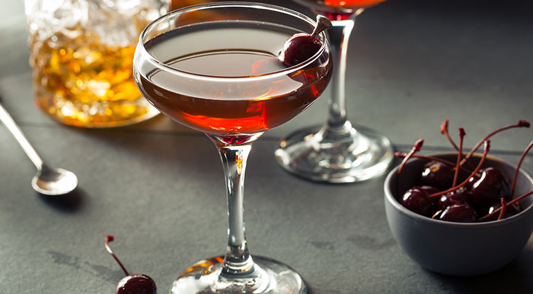 A Manhattan cocktail with cocktail cherry