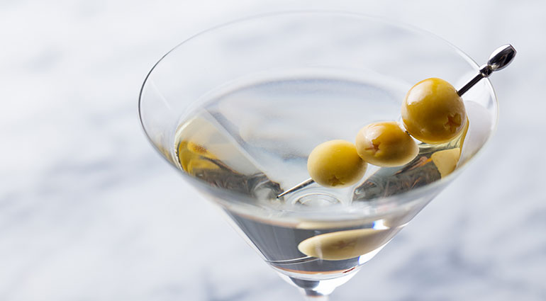 A Martini cocktail with olives