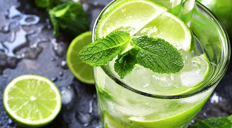 A Mojito cocktail with limes and fresh mint