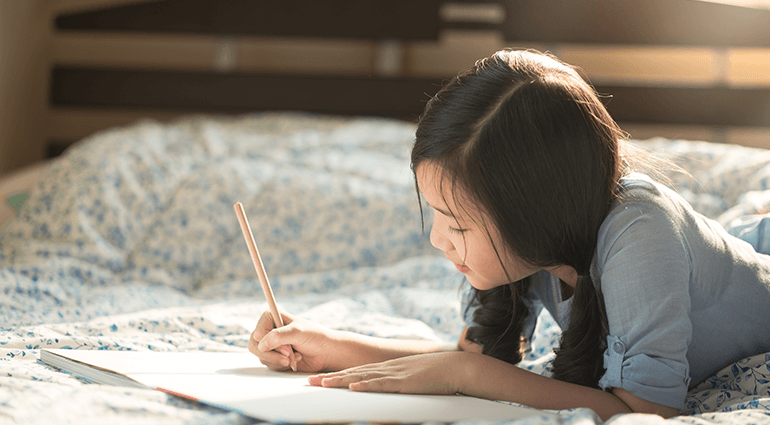 Girl writing in a journal