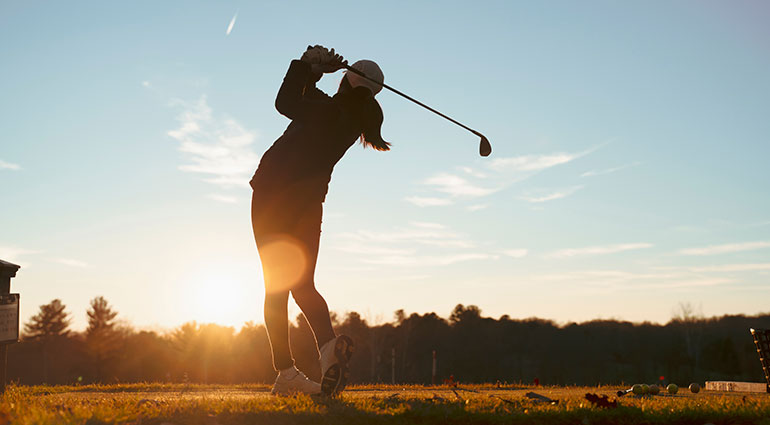 Golfer at sunset