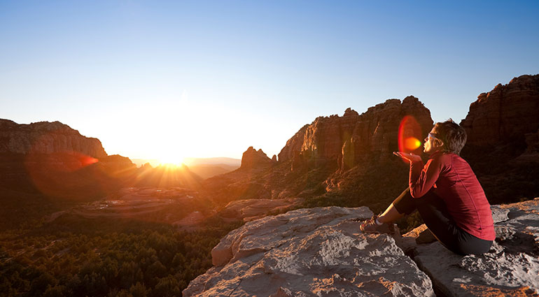 Woman watching sunrise in Arizona