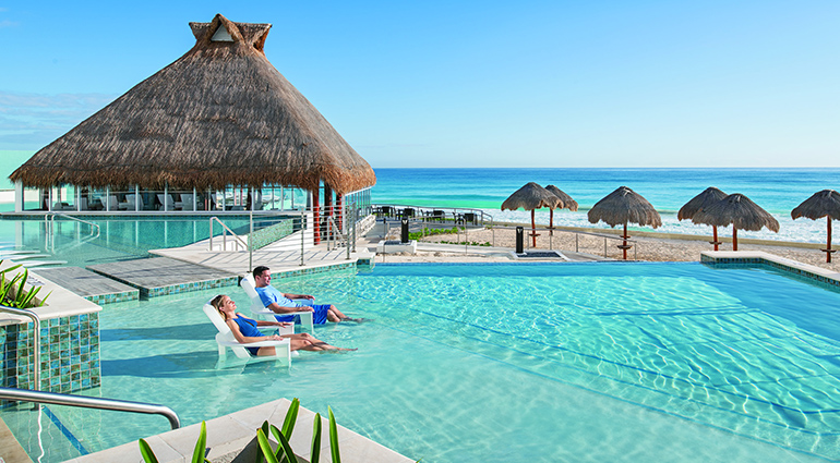Couple relaxing at the pool by the beach