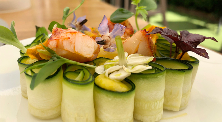 Lobster dish served cucumber and flowers in michelin star restaurant